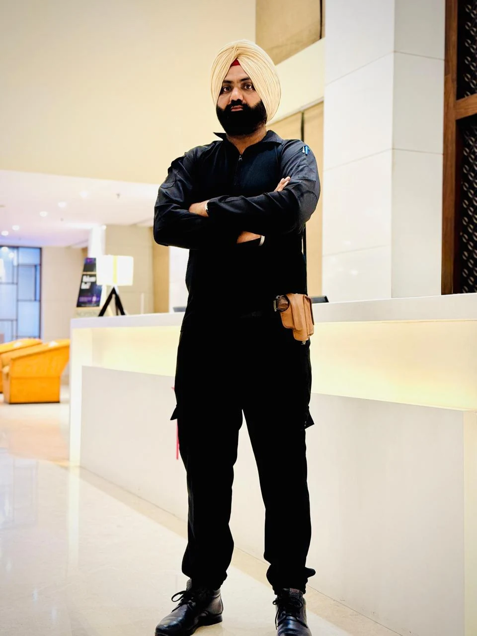 R CORPS security professional standing in a lobby