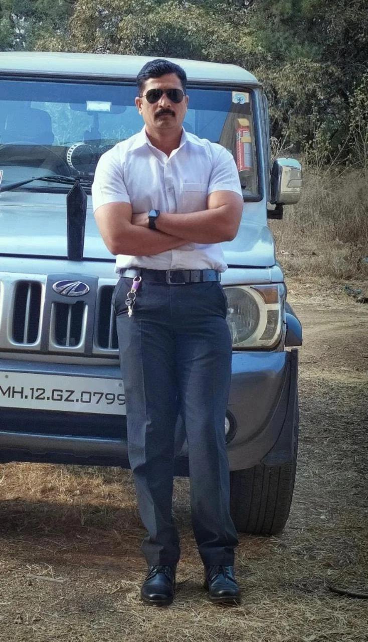 Supplied photograph of a personal security officer beside a vehicle